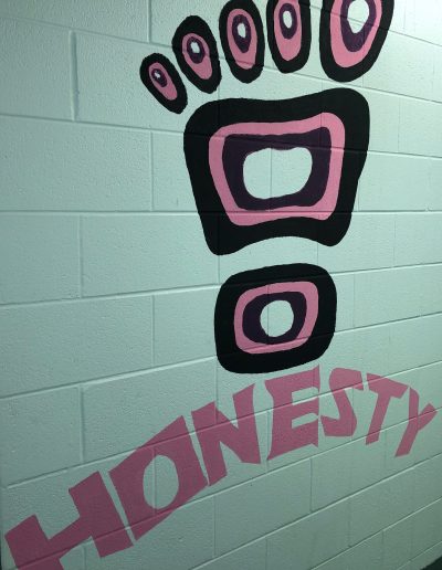 A mural depicting a bear paw and the word "honesty"