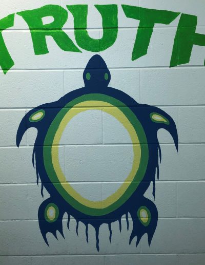A mural depicting a turtle and the word "truth"