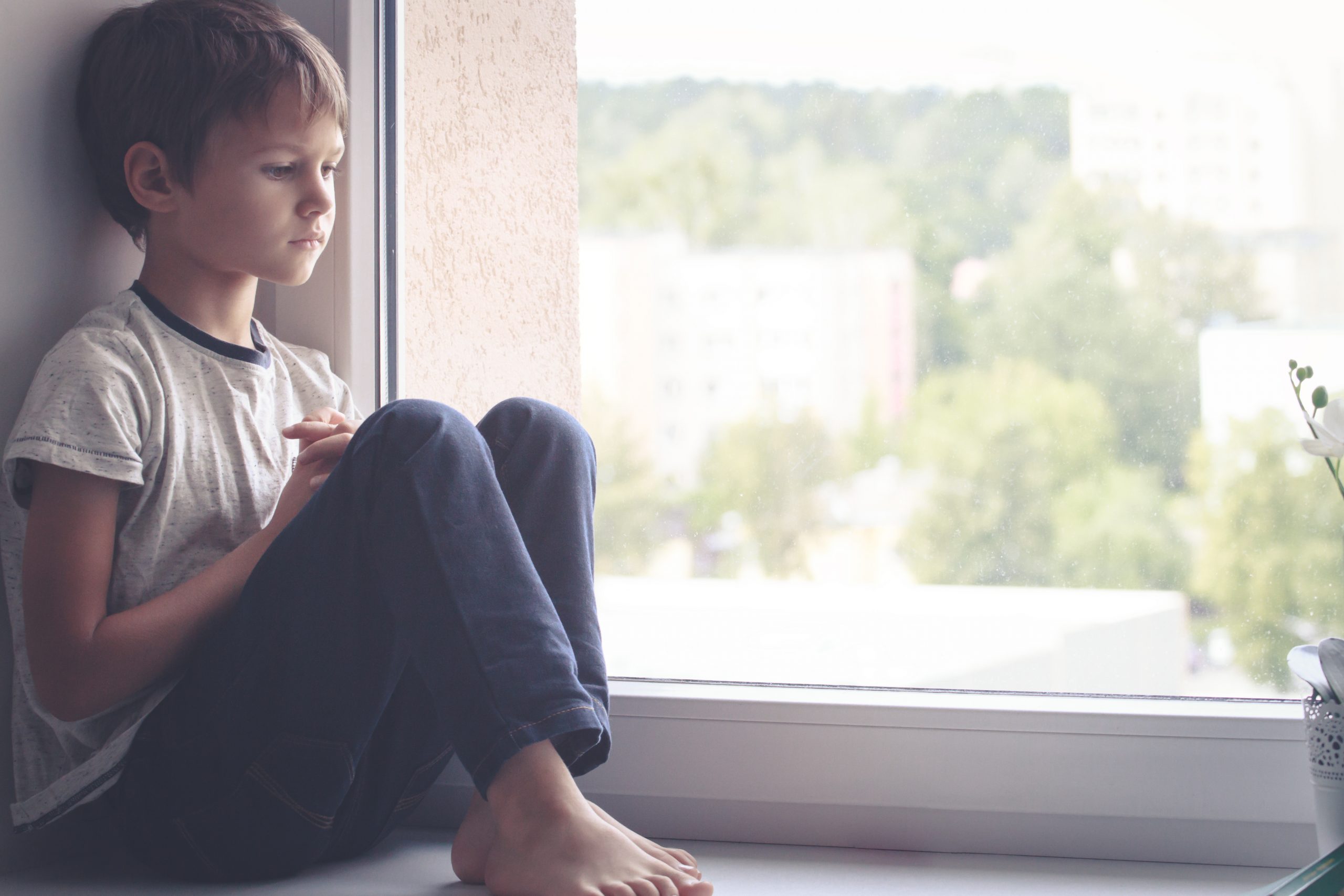 Sad child at a window